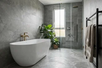 Plan 3D ultra réaliste d'une salle de bain moderne avec baignoire îlot, carrelage gris et robinetterie en laiton brossé